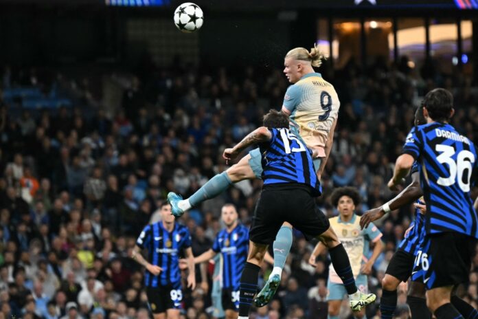 Manchester City's Norwegian striker #09 Erling Haaland (C) has this header saved during the UEFA Champions League, league phase football match between Manchester City and Inter Milan at the Etihad stadium, in Manchester, north-west England, on September 18, 2024 (Photo by Paul Ellis / AFP)