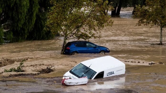 Image:Cars are swept away by the water in Alora, Malaga province. Pic: AP