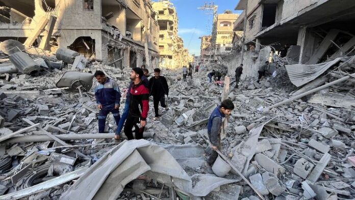 People check the rubble of a building hit in a deadly Israeli strike on Beit Lahia, northern Gaza — -