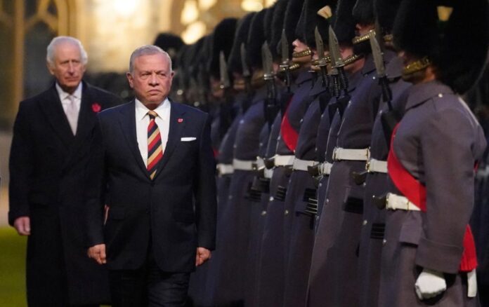 Britain’s King Charles III and Jordan’s King Abdallah II inspect a Guard of Honour formed of the 1st Battalion Welsh Guards, during a ceremonial welcome at Windsor Castle, in Windsor on November 7, 2024. (Photo by Andrew Matthews / POOL / AFP)  