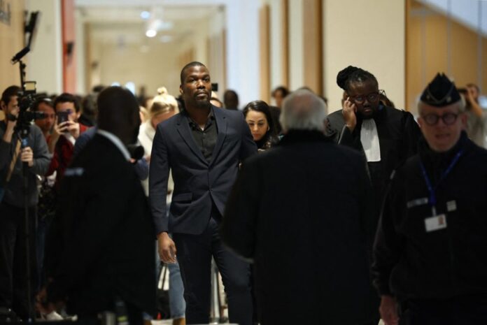 Mathias Pogba (C), who is accused of pressurising his brother French football player Paul Pogba and his family, arrives at the Paris Criminal Court for his trial, in Paris on November 26, 2024. – Six men included Pogba’s own brother Mathias, go on trial in Paris accused of blackmail, attempted extortion of millions of euros and holding the Juventus and France football player Paul Pogba at gunpoint in 2022. (Photo by Anne-Christine POUJOULAT / AFP)