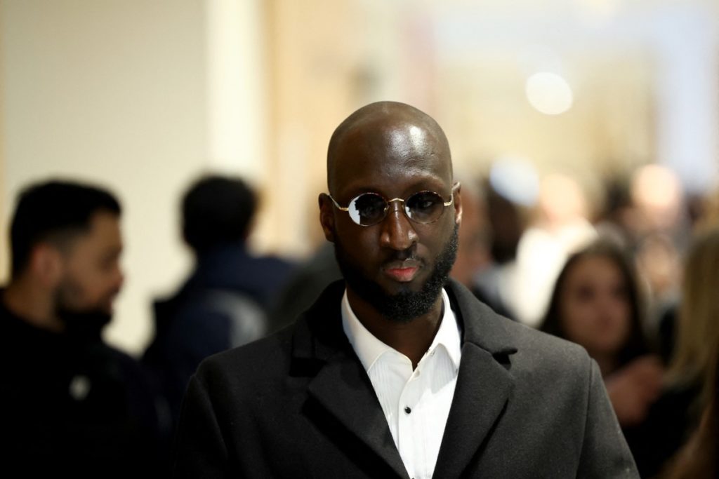 Camara Boubacar, who is accused of pressurising French football player Paul Pogba and his family, arrives at the Paris Criminal Court to attend the trial in Paris on November 26, 2024. – Six men included Pogba’s own brother Mathias, go on trial in Paris accused of blackmail, attempted extortion of millions of euros and holding the Juventus and France football player Paul Pogba at gunpoint in 2022. (Photo by Anne-Christine POUJOULAT / AFP)