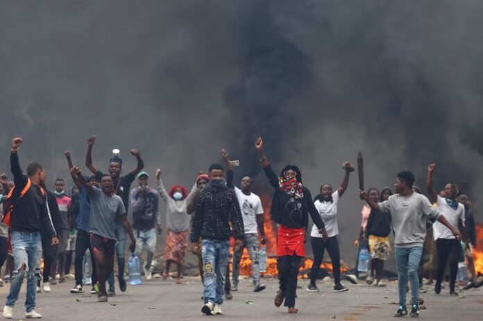 Protesters react during a 