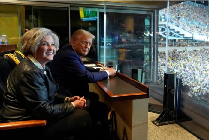 Republican presidential candidate and former President Donald Trump sits with Susie Wiles as he attends the New York Jets football game against the Pittsburgh Steelers at Acrisure Stadium, Sunday, Oct. 20, 2024, in Pittsburgh. Evan Vucci/Pool via REUTERS/File Photo 