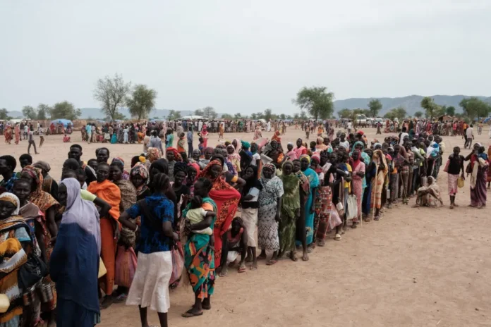 People line up to register for a potential food aid delivery at a camp for internally displaced persons (IDP) in South Kordofan, Sudan on June 17, 2024. Guy Peterson/AFP via Getty Images
