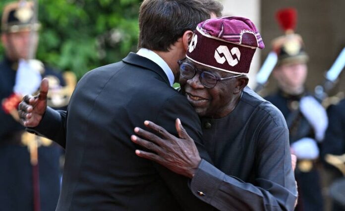 PARIS, FRANCE - JUNE 23: French President Emmanuel Macron (L) greets Nigeria's President Bola Tinubu (R) upon arrival for an official dinner at the Elysee Palace, on the sidelines of the New Global Financial Pact Summit in Paris, France on June 23, 2023. Mustafa Yalcinn / Anadolu Agency (Photo by Mustafa Yalcinn / ANADOLU AGENCY / Anadolu via AFP)