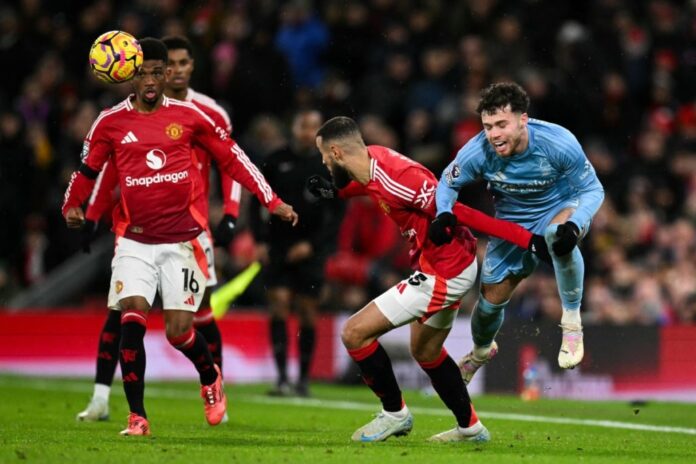 Manchester United’s Moroccan defender #03 Noussair Mazraoui (2nd R) fights for the ball Nottingham Forest’s Welsh defender #07 Neco Williams during the English Premier League football match between Manchester United and Nottingham Forest at Old Trafford in Manchester, north west England, on December 7, 2024. (Photo by Oli SCARFF / AFP)