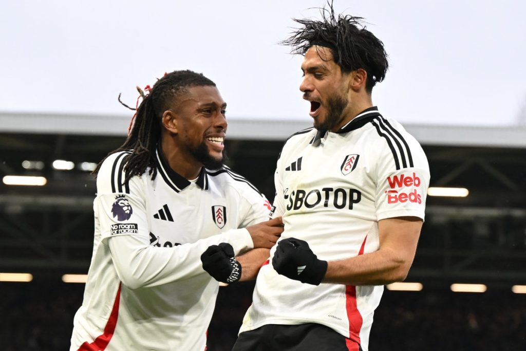 Fulham’s Mexican striker #07 Raul Jimenez (R) celebrates with Fulham’s Nigerian midfielder #17 Alex Iwobi (L) after scoring the opening goal during the English Premier League football match between Fulham and Arsenal at Craven Cottage in London on December 8, 2024. (Photo by JUSTIN TALLIS / AFP)