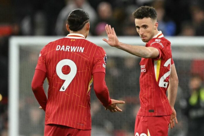 Liverpool’s Portuguese striker #20 Diogo Jota (R) celebrates with Liverpool’s Uruguayan striker #09 Darwin Nunez (L) after scoring their second goal during the English Premier League football match between Liverpool and Fulham at Anfield in Liverpool, north west England on December 14, 2024. (Photo by Oli SCARFF / AFP) / 