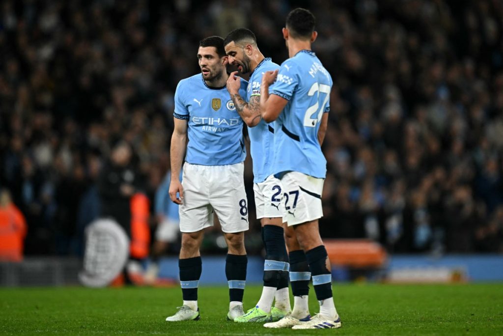Manchester City’s English defender #02 Kyle Walker (C) talks to Manchester City’s Croatian midfielder #08 Mateo Kovacic (L) during the English Premier League football match between Manchester City and Manchester United at the Etihad Stadium in Manchester, north west England, on December 15, 2024. (Photo by Paul ELLIS / AFP)