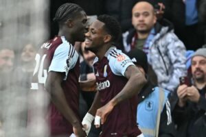 Aston Villa’s Columbian striker #09 Jhon Duran (C) celebrates with teammates after scoring the opening goal of the English Premier League football match between Aston Villa and Manchester City at Villa Park in Birmingham, central England on December 21, 2024. (Photo by Paul ELLIS / AFP).   