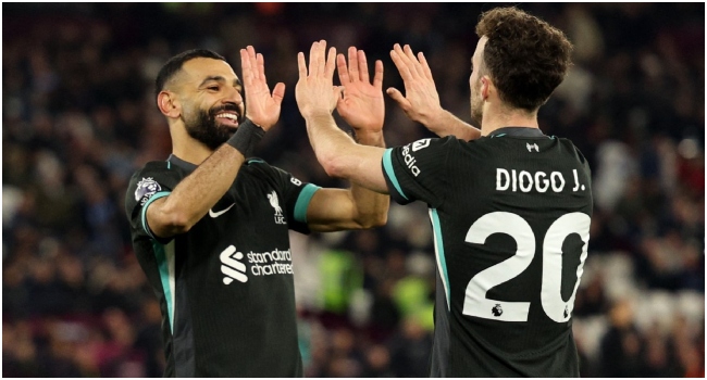 Liverpool’s Portuguese striker #20 Diogo Jota celebrates scoring the team’s fifth goal with Liverpool’s Egyptian striker #11 Mohamed Salah during the English Premier League football match between West Ham United and Liverpool at the London Stadium, in London on December 29, 2024. (Photo by Adrian Dennis / AFP)