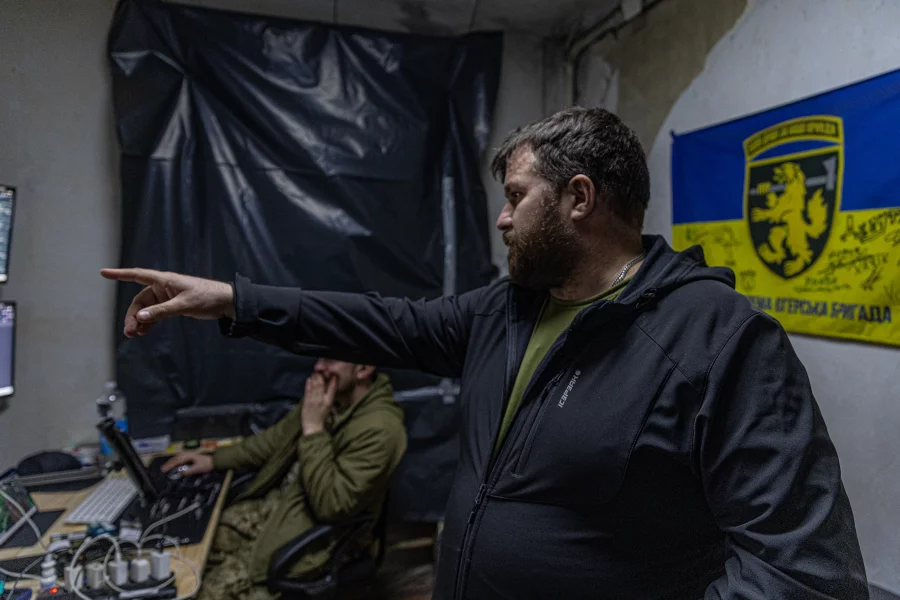 Callsign "Pip", a duty officer with the Dovbush's Hornets unit of 68th Separate Jäger Brigade (right). and callsign "Sonic" сommander of the strike UAV platoon watching unit's live streams and helping coordinate their attacks on Russian units. Anton Shtuka for NPR