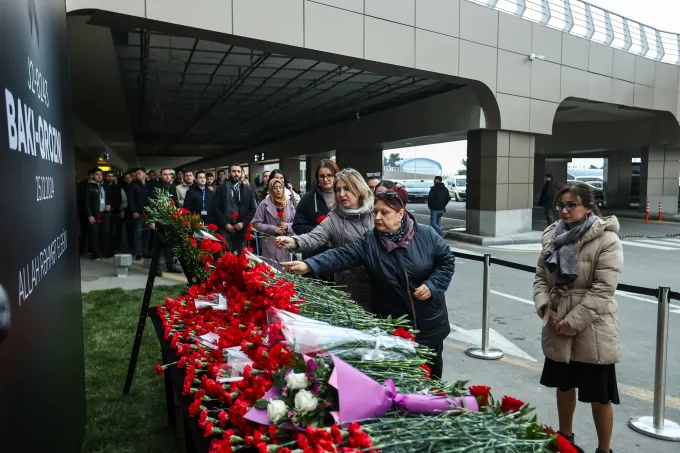 People lay flowers in memory of the victims of the disaster near Kazakhstan's Aktau airport.   Aziz Karimov/Getty Images