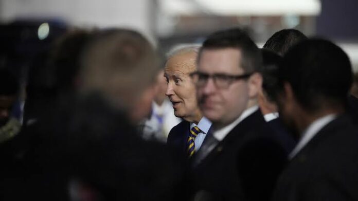 President Joe Biden greets well wishers after arriving at Quatro de Fevereiro international airport in the capital Luanda, Angola on Monday, Dec. 2, 2024, on his long-promised visit to Africa. (AP Photo/Ben Curtis)