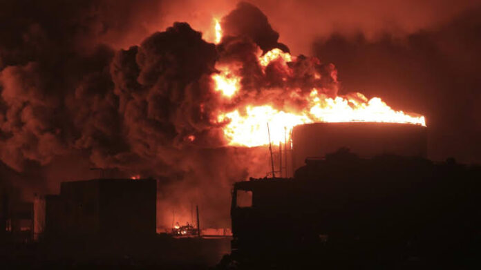 Oil tanks burn at the port in Hudaydah, Yemen. Experts say Israel’s retaliatory strike on Houthi rebels after their attack on Tel Aviv may just encourage the Iran-backed militant group.  (Associated Press)