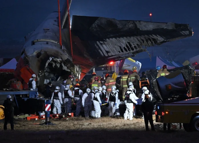 Firefighters and rescue personnel carry the body of a victim near the scene where a Jeju Air Boeing 737-800 series aircraft crashed and burst into flames at Muan International Airport in South Jeolla Province, some 288 kilometers southwest of Seoul on December 29, 2024. Jung Yeon-je, AFP/File