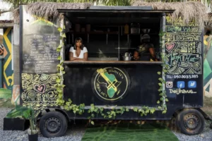 Deijha Gordon, 33, poses for a photograph in her food truck in Accra, Ghana, Wednesday, Dec. 11, 2024. Deijha, who relocated from New York, has obtained Ghanaian citizenship. (AP Photo/Misper Apawu)