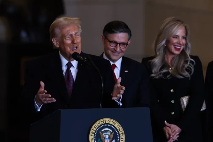Trump speaks to the crowd alongside House Speaker Mike Johnson in the VIP overflow viewing area in Emancipation Hall after his inauguration at the U.S. Capitol. Pool/Getty Images
