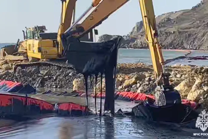 In this photo taken from video released by Russian Emergency Ministry Press Service on Friday, Jan. 17, 2025, an excavator works removing oil near the damaged Volgoneft-239 tanker from which the fuel oil continues to leak into the sea near the port of Taman in Russia’s southern Krasnodar region. (Russian Emergency Ministry Press Service via AP)