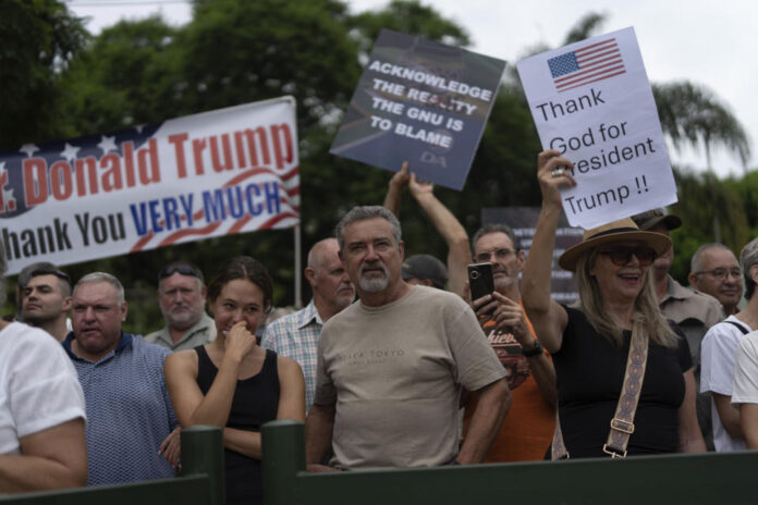White South Africans demonstrate in support of U.S. President Donald Trump in front of the U.S. embassy in Pretoria, South Africa, Saturday, Feb. 15, 2025. (AP Photo/Jerome Delay) ASSOCIATED PRESS