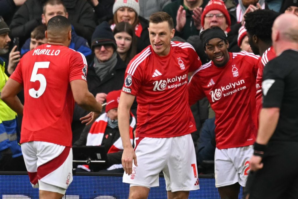 Nottingham Forest’s New Zealand striker #11 Chris Wood (C) celebrates with teammates after scoring their fourth goal during the English Premier League football match between Nottingham Forest and Brighton and Hove Albion at The City Ground in Nottingham, central England, on February 1, 2025. (Photo by Oli SCARFF / AFP)
