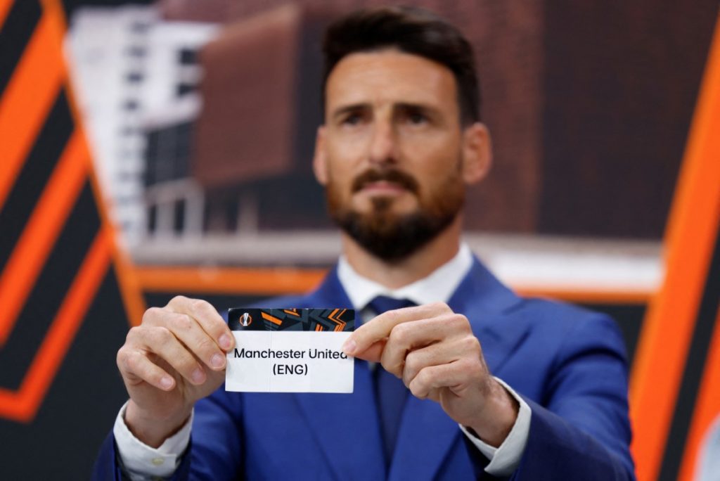 Spanish former football international Aritz Aduriz holds up the slip of Manchester United during the draw for the round of 16 of the 2024-2025 UEFA Europa League football tournament at the House of European Football in Nyon, on February 21, 2025. (Photo by Valentin Flauraud / AFP)