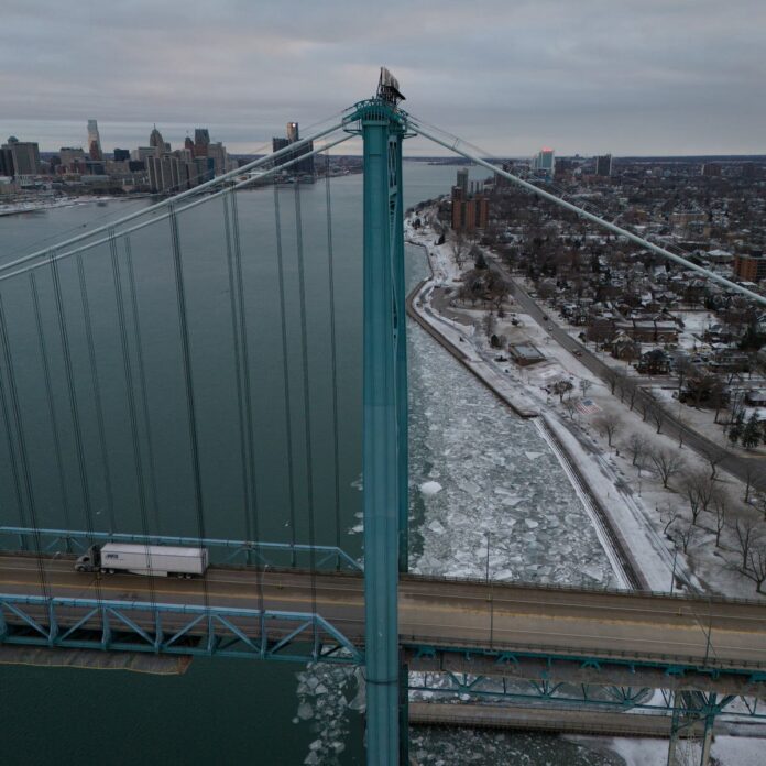 The Ambassador Bridge, where $400 billion in trade crosses between Canada and the United States each year, connects Detroit with Windsor, Ontario.Credit...Ian Willms for The New York Times
