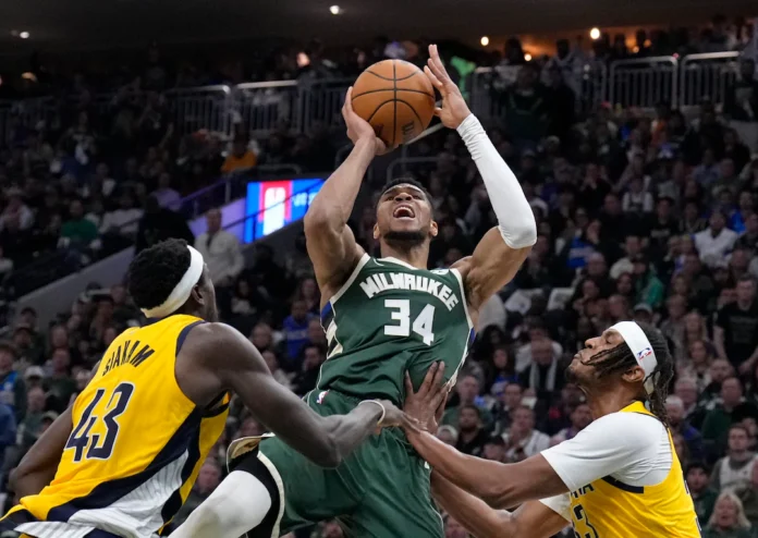 Apr 25, 2025; Milwaukee, Wisconsin, USA; Milwaukee Bucks forward Giannis Antetokounmpo (34) puts up a shot against Indiana Pacers forward Pascal Siakam (43) and Indiana Pacers center Myles Turner (33) in the second half during game three of first round for the 2024 NBA Playoffs at Fiserv Forum. Mandatory Credit: Michael McLoone-Imagn Images