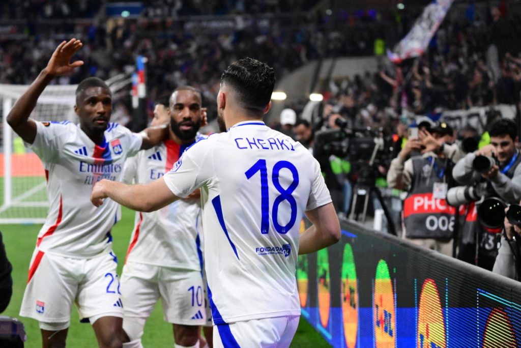 Lyon’s French midfielder #18 Rayan Cherki celebrates, with Lyon’s Angolan defender #22 Clinton Mata (L) and Lyon’s French forward #10 Alexandre Lacazette (C), scoring his team’s second goal during the UEFA Europa League Quarter final first leg football match between Olympique Lyonnais (OL) and Manchester United at the Parc Olympique Lyonnais Groupama stadium in Decines-Charpieu, central-eastern France, on April 10, 2025. (Photo by Olivier CHASSIGNOLE / AFP)