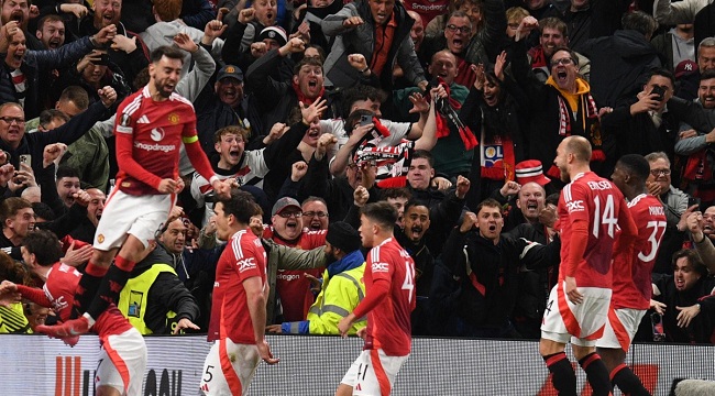 Manchester United’s English defender #05 Harry Maguire (2L) and teammates celebrate with their fans after Maguire scores their fifth goal during the UEFA Europa League quarter-final final, second leg football match between Manchester United and Lyon at Old Trafford stadium in Manchester, north west England, on April 17, 2025. (Photo by Oli SCARFF / AFP)