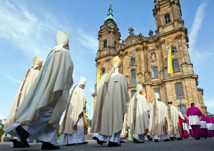 Bavarian bishops walk in a procession to the Basilica of the Fourteen Holy Helpers near Bad Staffelstein, Germany, in May. A decree by the German bishops' conference warns that German Catholics who do not pay a state church tax will be denied sacraments. Daniel Karmann/EPA/Landov