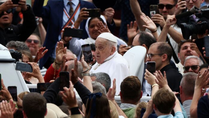 Pope Francis being driven through the crowds in St Peter's Square. Pic: Reuters
