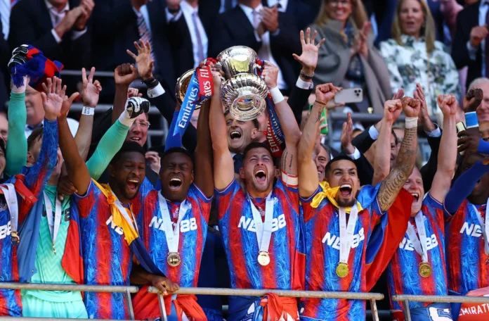 Soccer Football - FA Cup - Final - Crystal Palace v Manchester City - Wembley Stadium, London, Britain - May 17, 2025 Crystal Palace's Marc Guehi and Joel Ward lift the trophy as they celebrate with teammates after winning the FA Cup Action Images via Reuters/Andrew