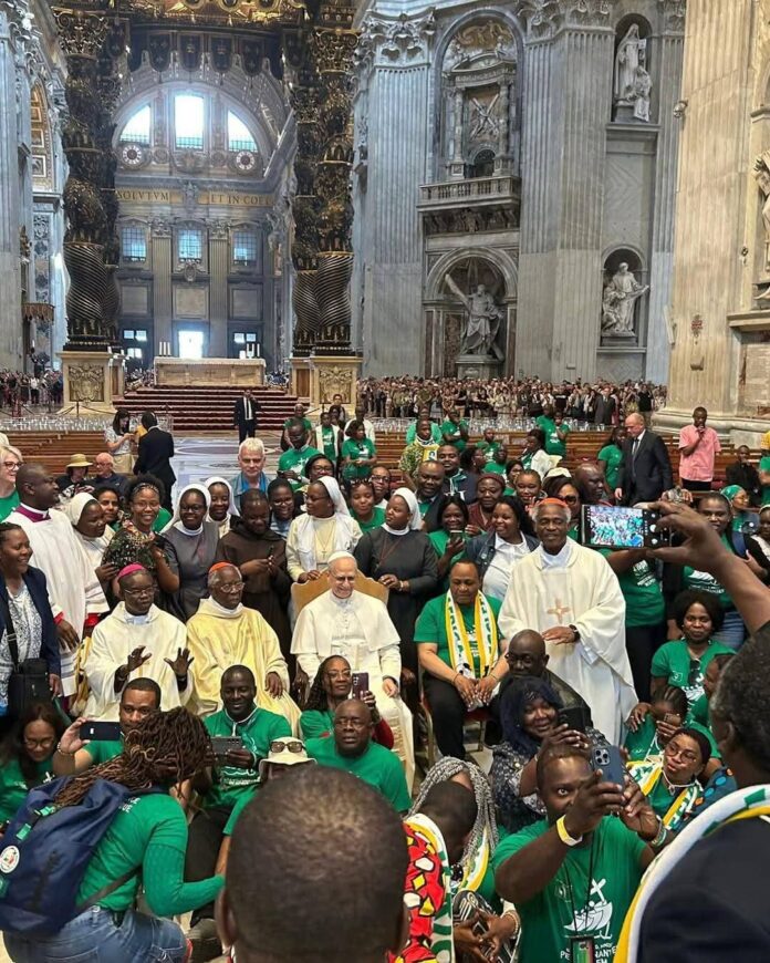 Pope Leo XIV takes a group photo with those who attended the Mass in St. Peter's Basilica on May 26, 2025
