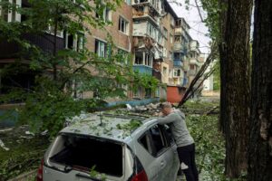 A man looks at his car that was damaged during a Russian attack, amid Russia's attack on Ukraine, in Kyiv, Ukraine, May 24, 2025. REUTERS/Thomas Peter