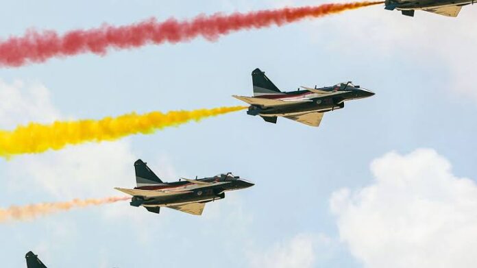 Military aircraft fly in formation, as tourists look on, at the Giza pyramid complex, as China and Egypt conduct their first joint air force exercise, in Giza, Egypt May 1, 2025 Military aircraft fly in formation, as tourists look on, at the Giza pyramid complex, as China and Egypt conduct their first joint air force exercise, in Giza, Egypt May 1, 2025