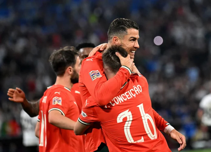 Soccer Football - Nations League - Semi Final - Germany v Portugal - Allianz Arena, Munich, Germany - June 4, 2025 Portugal's Cristiano Ronaldo celebrates scoring their second goal with Portugal's Nuno Mendes REUTERS/Angelika Warmuth