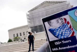 A law enforcement officer stands guard on the day the Supreme Court justices hear oral arguments over U.S. President Donald Trump's bid to broadly enforce his executive order to restrict automatic birthright citizenship, during a protest outside the U.S. Supreme Court in Washington, D.C., U.S., May 15, 2025. REUTERS/Nathan Howard/File Photo 