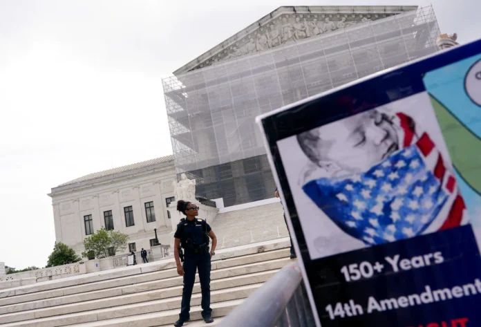 A law enforcement officer stands guard on the day the Supreme Court justices hear oral arguments over U.S. President Donald Trump's bid to broadly enforce his executive order to restrict automatic birthright citizenship, during a protest outside the U.S. Supreme Court in Washington, D.C., U.S., May 15, 2025. REUTERS/Nathan Howard/File Photo 