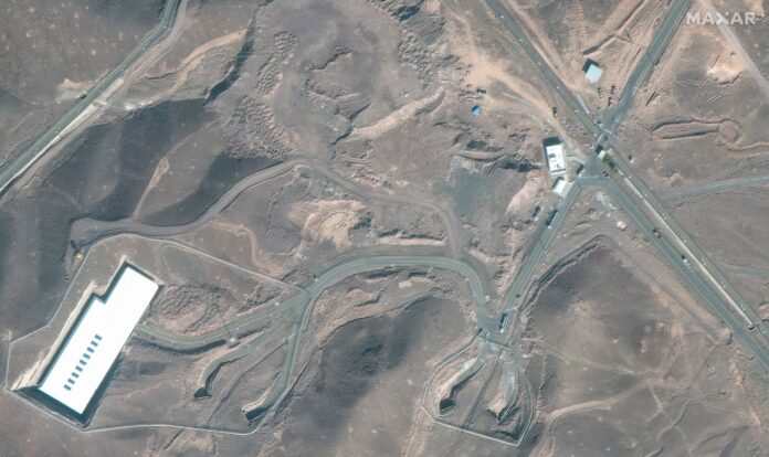 A satellite image shows trucks and bulldozers near the entrance to the Fordow nuclear facility, near Qom, Iran June 20, 2025. Maxar Technologies/Handout via REUTERS