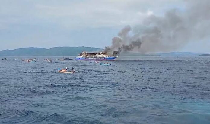 In this photo made from video released by the Indonesian National Search and Rescue Agency (BASARNAS), smoke billows from passenger ship KM Barcelona after it caught fire in the waters off Talise Island in North Sulawesi, Indonesia, Sunday, July 20, 2025. (BASARNAS via AP)