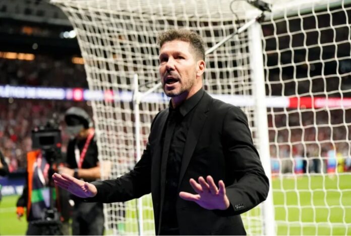 Atletico Madrid coach Diego Simeone tried to calm down the Atletico Madrid fans after play was stopped due to crowd trouble [Ana Beltran/Reuters]