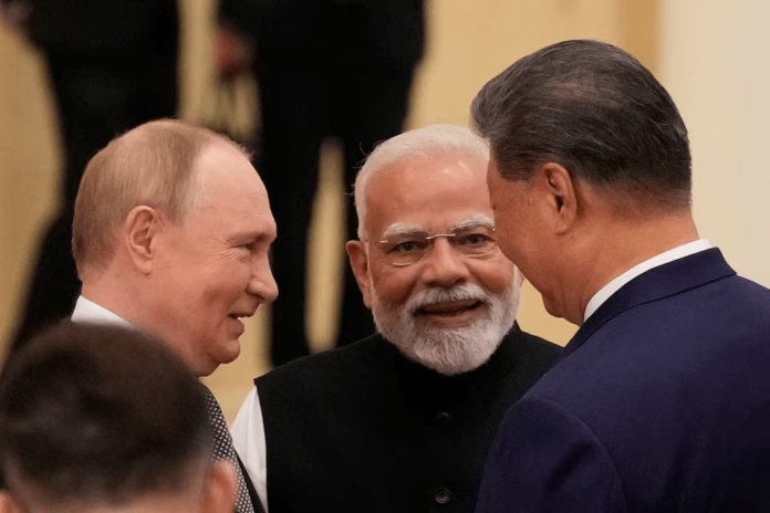 Indian Prime Minister Narendra Modi talks with Russian President Vladimir Putin and Chinese President Xi Jinping ahead of the Shanghai Cooperation Organization (SCO) Summit 2025 at the Meijiang Convention and Exhibition Centre in Tianjin, China, September 1, 2025. SUO TAKEKUMA/Pool via REUTERS Source URL : China's Xi pushes a new global order, flanked by leaders of Russia and India | The Standard https://www.thestandard.com.hk/china-news/article/310485/