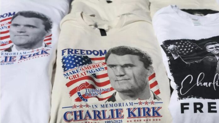 Charlie Kirk tee-shirts are sold near the State Farm Stadium as it prepares to host a memorial service on September 20, 2025, in Glendale, Arizona. © Joe Raedle, Getty Images via AFP