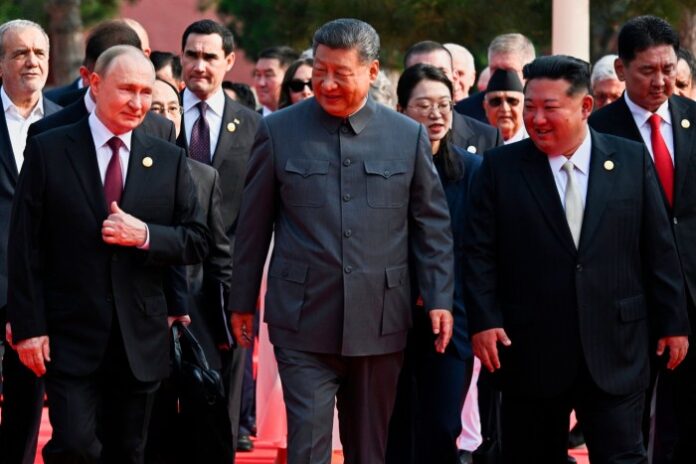 Russian President Vladimir Putin, left, Chinese President Xi Jinping and North Korean leader Kim Jong Un © AP