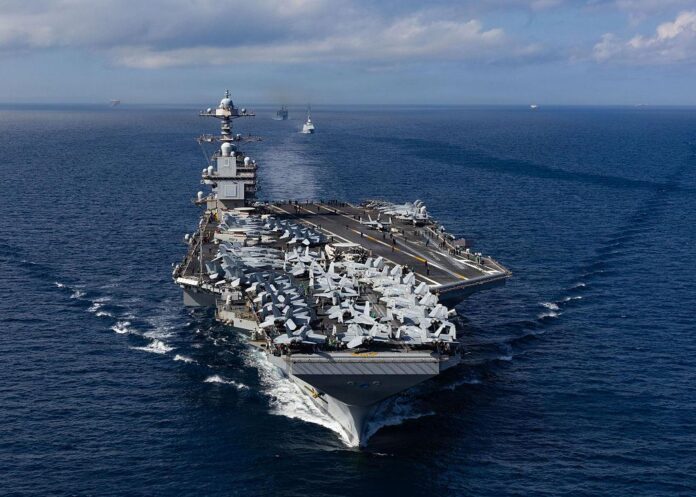 In this handout provided by the U.S. Navy, The From front to back, the USS Gerald R. Ford (CVN 78), Royal Moroccan Navy FREMM multipurpose frigate Mohammed VI (701), and Military Sealift Command fast combat support ship USNS Supply (T-AOE 6), steam in formation while transiting the Strait of Gibraltar, on October 1, 2025. In this handout provided by the U.S. Navy, The From front to back, the USS Gerald R. Ford (CVN 78), Royal Moroccan Navy FREMM multipurpose frigate Mohammed VI (701), and Military Sealift Command fast combat support ship USNS Supply (T-AOE 6), steam in formation while transiting the Strait of Gibraltar, on October 1, 2025.