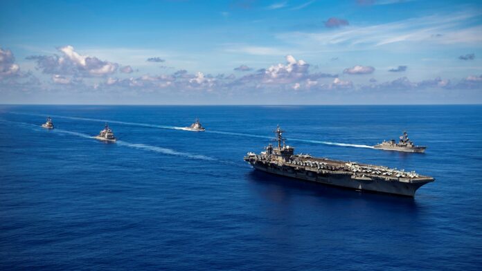 Vessels of the U.S. Navy and Japan Maritime Self-Defense Force conduct a passing honors ceremony in the Pacific Ocean, Sept. 19, 2021 (U.S. Navy photo by Haydn N. Smith via AP).