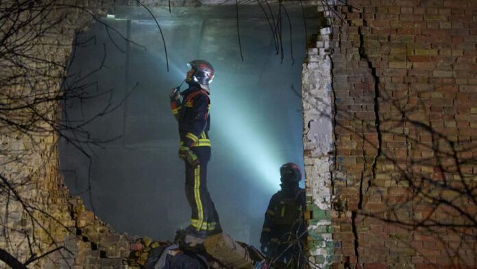 Rescuers search for victims after a drone hit a residential building during Russia's night missile and drone attack in Kyiv, Ukraine, Saturday. Nov. 29, 2025. Associated Press