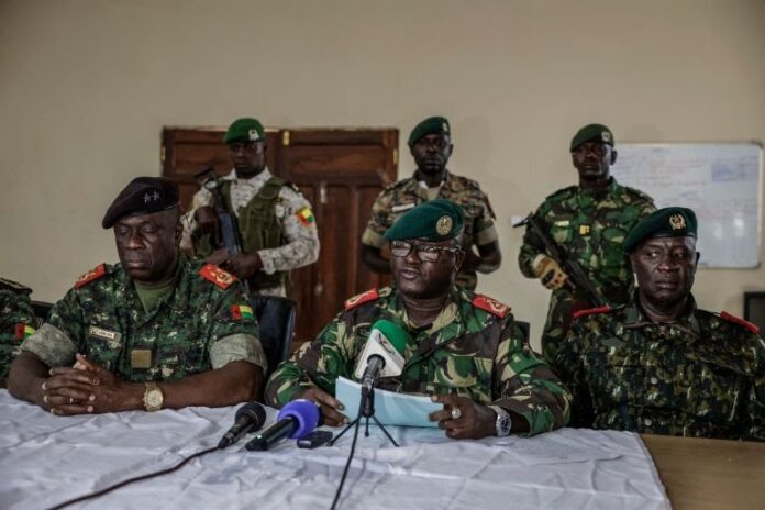 Brigadier General Denis N'Canha, head of the military office of the Guinea-Bissau presidency, announces the government takeover on November 26, 2025 [Patrick Meinhardt/AFP]